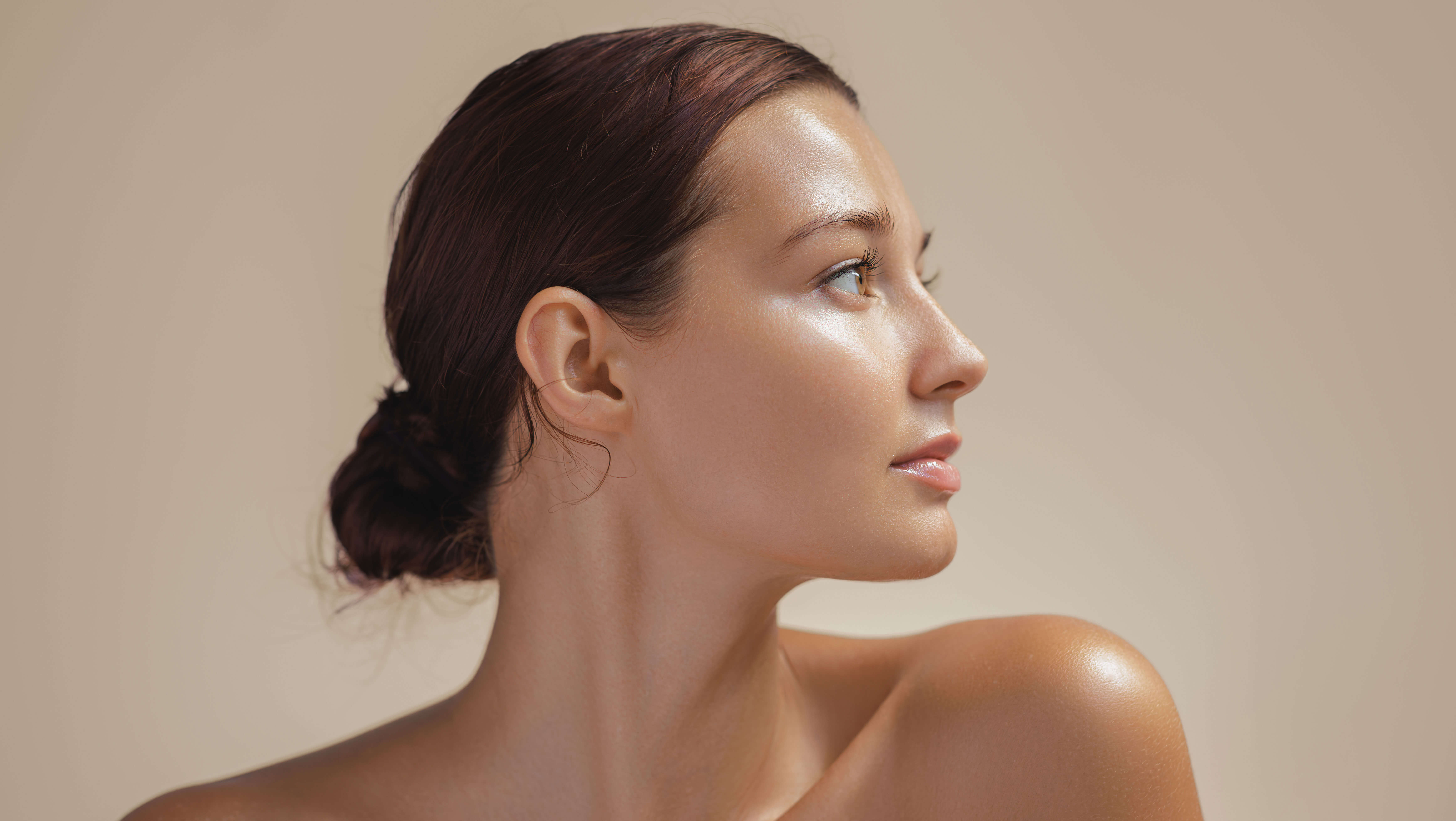 rofile view of a woman with smooth, glowing skin and youthful features, representing natural beauty and aesthetic treatments