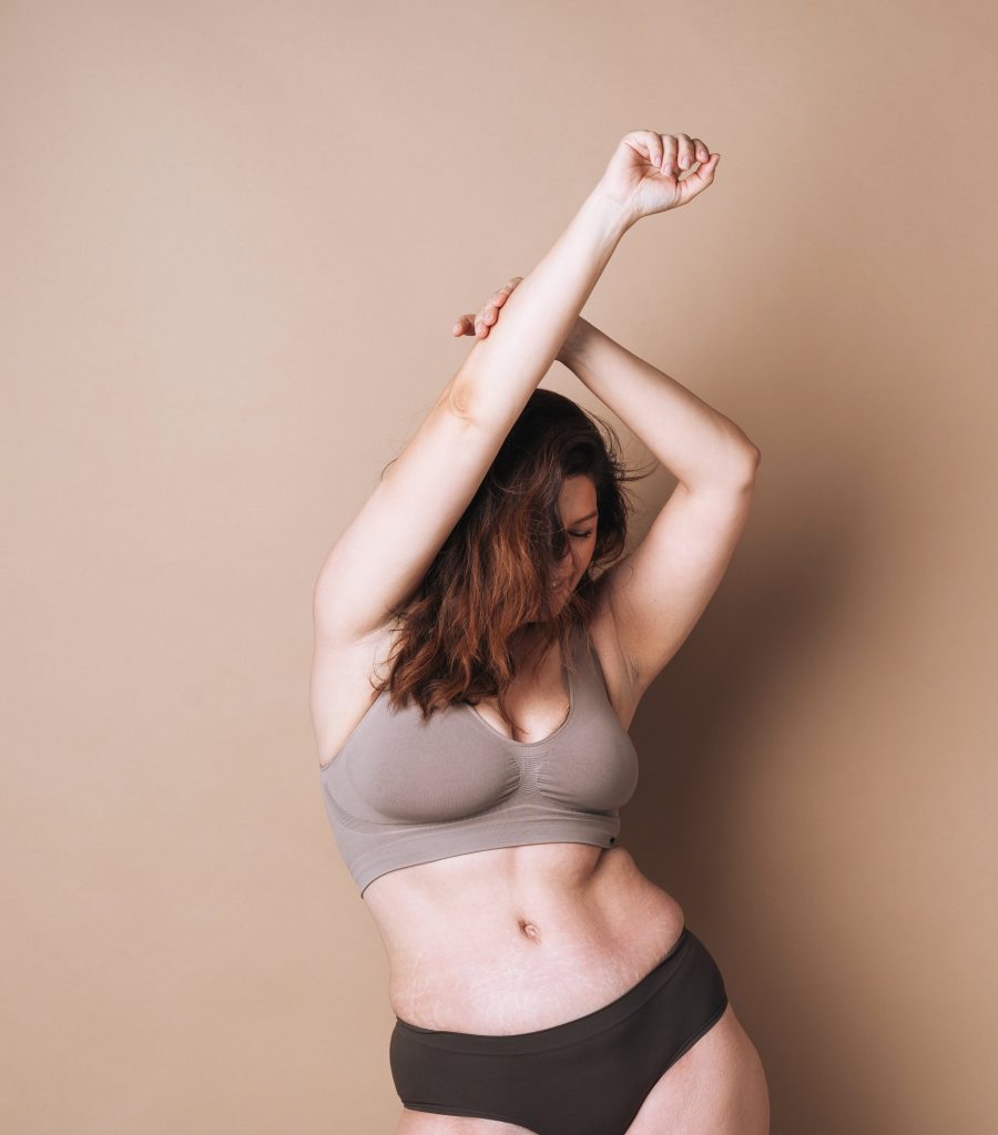 Photo of a happy woman after seeing her body lift results