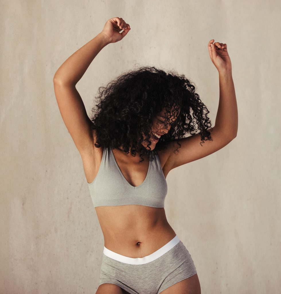 Photo of a happy woman in gray underwear