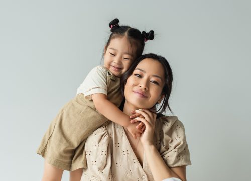 Photo of a mother being hugged by her daughter