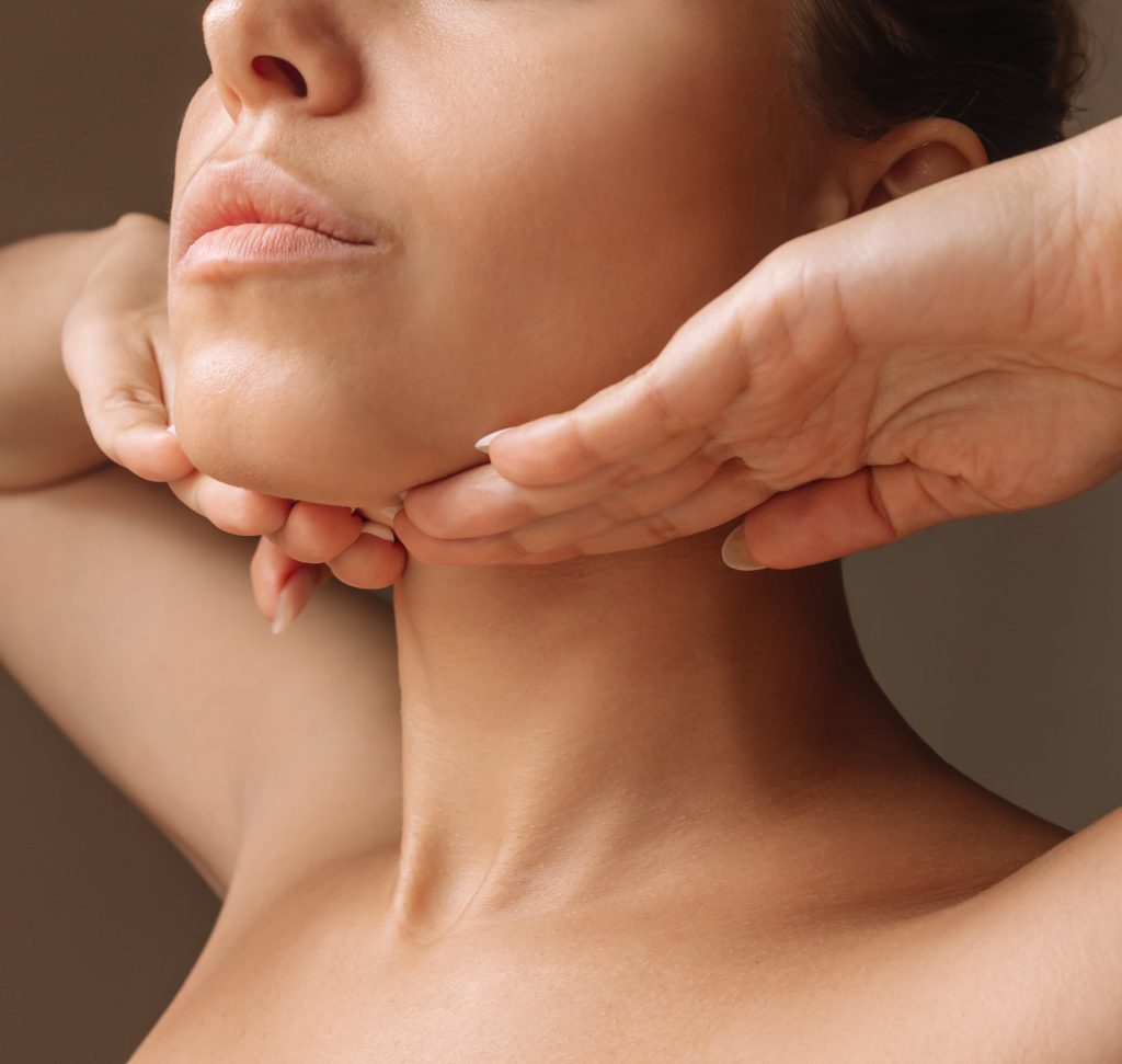 Photo of a woman hiding the loose skin on her neck