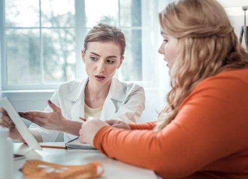 Photo of a plastic surgeon meeting with a patient