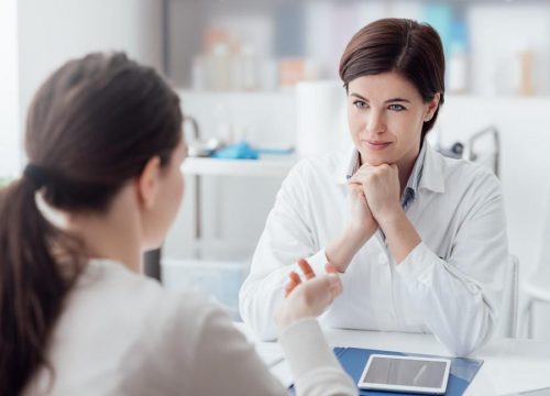 Photo of a plastic surgeon meeting with a patient