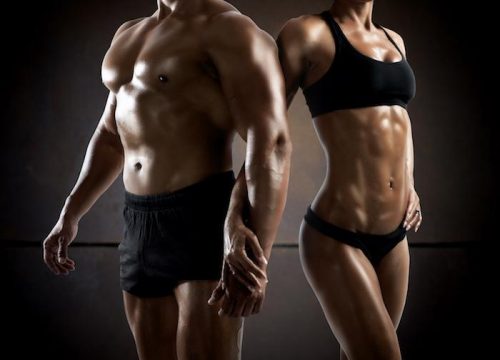 Photo of a muscular man and muscular woman in black workout clothes