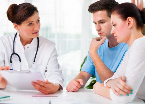 Photo of a couple meeting with their doctor