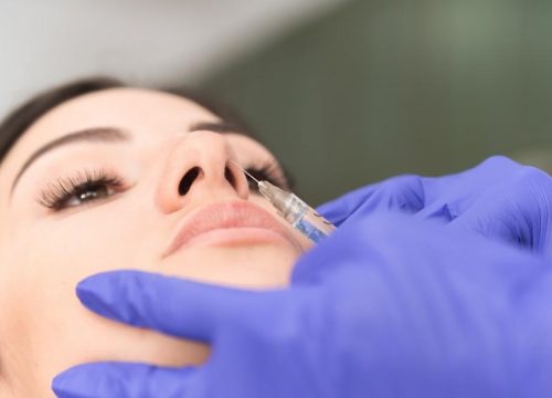 Photo of a woman getting an injectable treatment in her nose